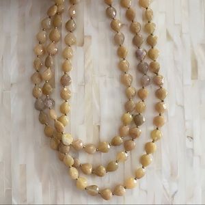 Neutral beaded long  layered necklace.